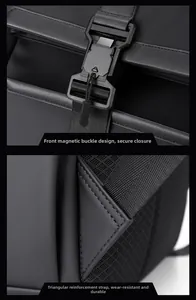 Detail of magnetic buckle and reinforced triangular stitching on black travel backpack