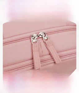 Detail of high-quality pink nylon bag featuring smooth dual metal zippers with cord pulls