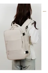 Beige large travel backpack with multi-layer pockets and side buckle detail