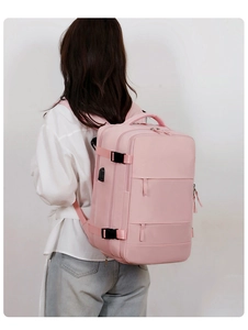 Pink multi-functional travel backpack with USB charging port shown on person's back