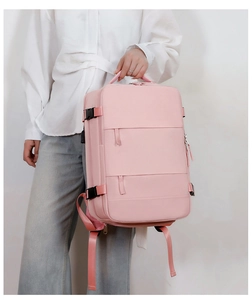 Close-up of pink nylon travel backpack with multiple zippers and spacious compartments