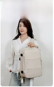 Detail of beige travel backpack featuring multi-layer compartments and side buckles