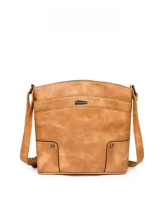 Detail view of brown vintage PU leather crossbody bag with pebble texture and rivets