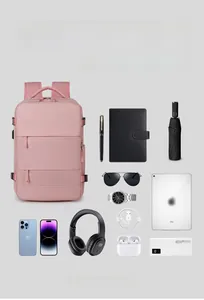 Detail of pink nylon backpack storage compartments organized with electronics and daily items