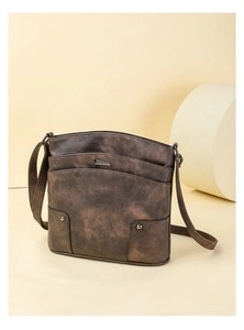 Detailed close-up of brown vintage PU leather crossbody bag with multi-layer pockets
