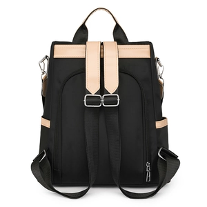 Black anti-theft nylon backpack with beige leather accents and rear zipper opening
