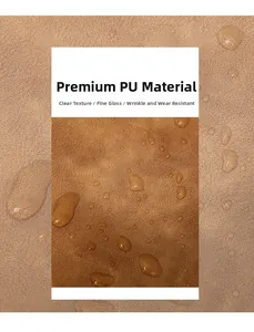 Detailed macro view of brown PU leather texture showing waterproof surface and water drops