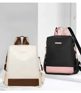 Détails de sacs à dos en tissu Oxford bicolore avec plaque logo et poches latérales
