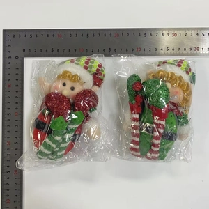 Detail of Christmas elf dolls with striped hats showing 18cm height on a measurement scale