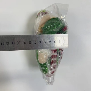 Detailed size measurement of a Christmas elf plush showing a width of 8cm with a metal ruler