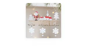 Detail of wooden Christmas sign featuring Santa, laser-cut letters and silver metal bells