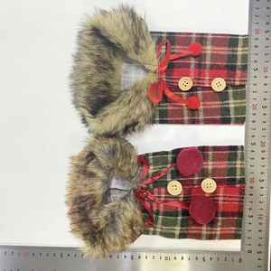 Detail of red and green plaid Christmas wine bottle covers with faux fur and wood buttons