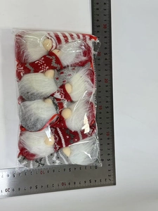 Detail view of 5-piece knitted Christmas gnome ornaments with red hanging loops and rulers