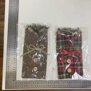 Detailed view of plaid Christmas wine bottle covers with faux fur trim and wooden buttons