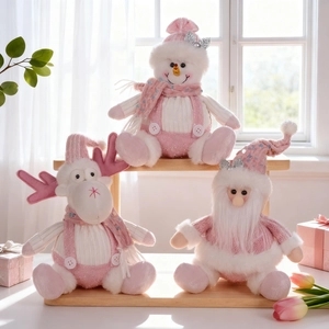 Set of three pink plush Christmas dolls including snowman and reindeer decorations