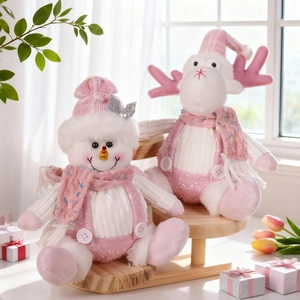 Pink Christmas snowman and reindeer plush dolls with sequins on a wooden display stand