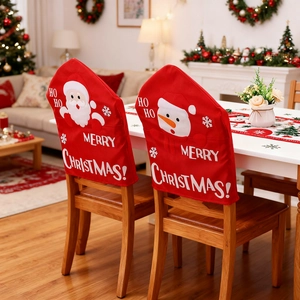 Festive red Christmas chair covers with Santa and Snowman motifs in a cozy home setting