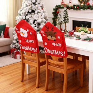 Cozy festive dining scene featuring red Merry Christmas chair covers with snowman and elk