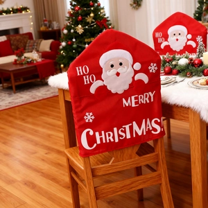 Detail of red Christmas chair covers with Santa Claus applique and festive holiday lettering