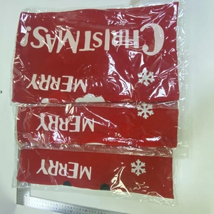 Detail view of red Merry Christmas fabric chair covers with white snowflake printing