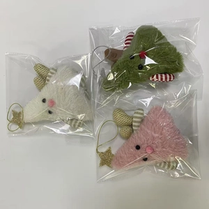 Detailed view of plush Christmas tree ornaments with golden stars in three colors