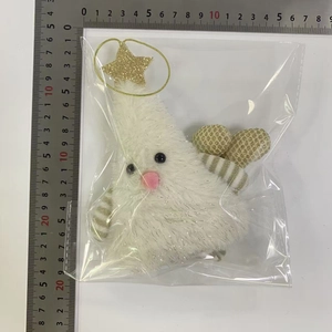 Detail of white plush Christmas tree ornament with gold star, measuring approximately 12cm