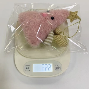 Pink plush Christmas tree ornament weight detail showing 22.2g on a scale