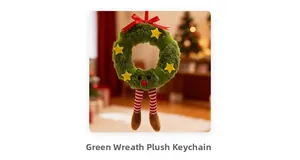 Close-up of a green plush Christmas wreath ornament with a cute face and red bow