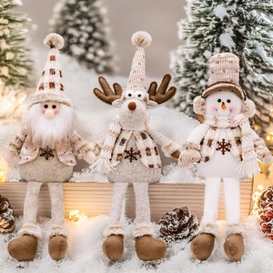 Three plush Christmas figurines of Santa, Reindeer, and Snowman with plaid accents