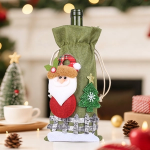 Detailed Christmas linen wine bag featuring a 3D Santa and fence on a cozy table