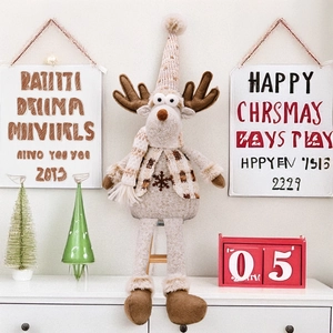 Close-up of plush Christmas reindeer doll with scarf and snowflake embroidery in home setting