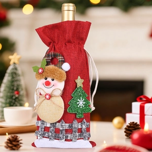 Detailed view of red burlap wine bottle cover featuring snowman and Christmas tree decor