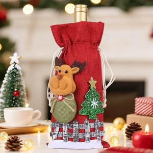 Close-up of burlap wine bottle cover featuring felt reindeer and snowy tree decor