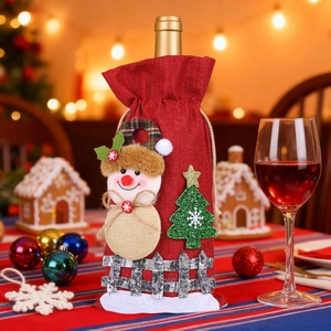 Detail of red burlap wine bottle cover with snowman and green Christmas tree decoration
