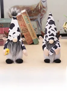 Detail of cow-themed gnomes with horn accents, holding a milk bottle and yellow flower