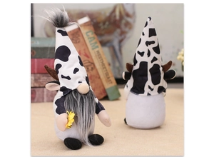Detail of cow print gnomes with antlers and sunflower for rustic home decoration