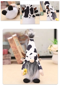 Detail of cow-print gnome plush with gray beard holding a yellow sunflower with a bee