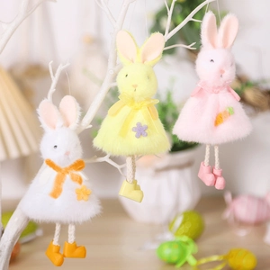 Detail of three colorful plush Easter bunnies with knitted legs hanging on a white branch
