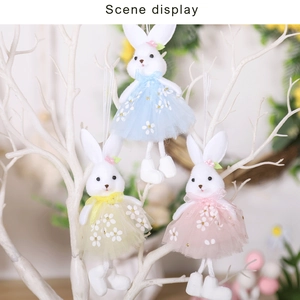 Detailed view of pastel plush Easter bunny pendants hanging on white decorative branches
