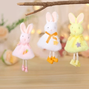 Detailed view of three plush Easter bunny ornaments in pink, white, and yellow colors