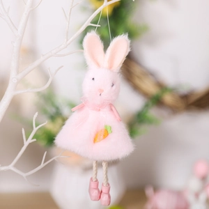 Pink plush bunny ornament with carrot detail hanging on a decorative white branch