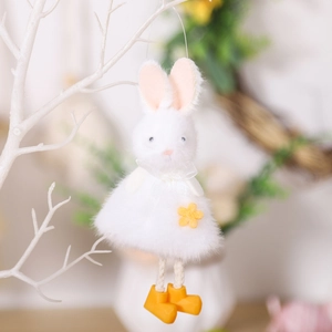 Plush Easter bunny ornament with yellow boots and floral detail hanging on a white branch