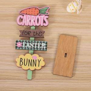 Detail of wooden Easter Bunny sign with carrots text and colorful cloud patterns on wood base