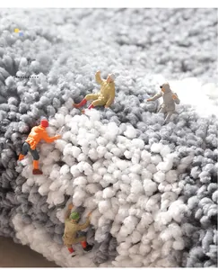 Macro shot of high-density plush grey bathroom mat fibers with miniature climber figures