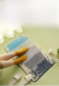 Detail of color-block flocked bath mat with soft absorbent texture and gray edging
