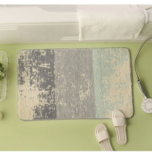 Detailed view of the long-pile texture on a gradient blue and grey bathroom floor mat