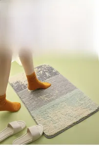 Close-up of thick plush bath mat with colorful patchwork design and anti-slip edge