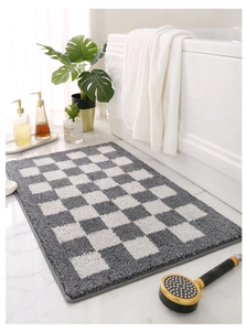 Gros plan d'un tapis de bain à carreaux gris avec texture pelucheuse et bords renforcés