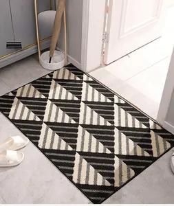 Detailed macro view of black and white geometric doormat showing durable fiber texture