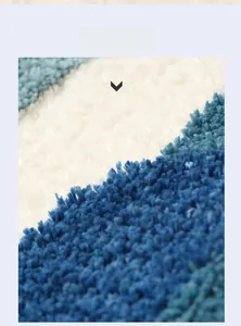 Close-up of high-low pile bath mat with three-dimensional blue and white fibers